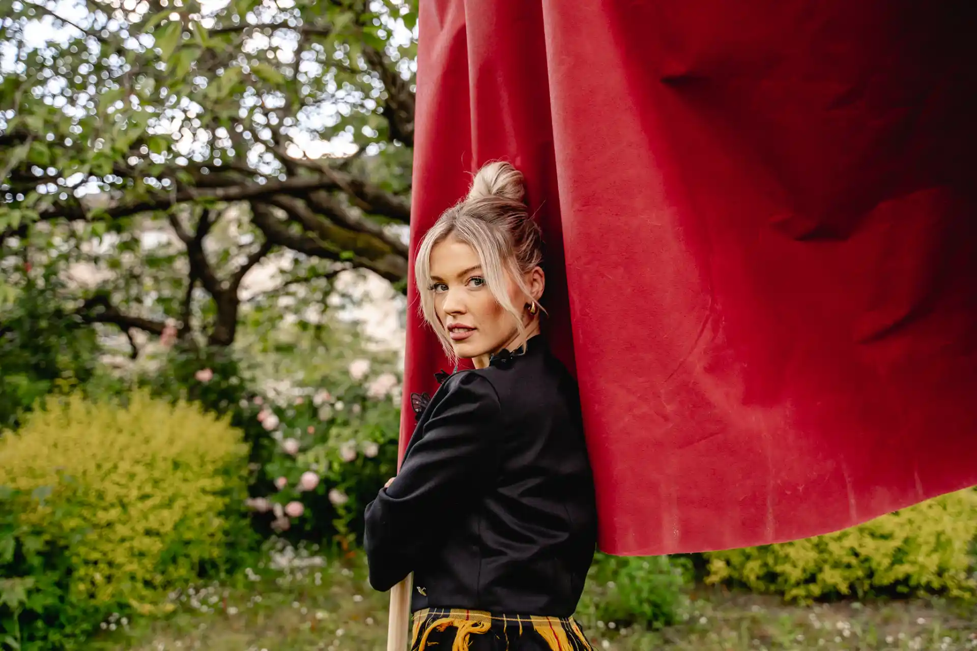 Siobhan Mackenzie outdoors holding a red flag.