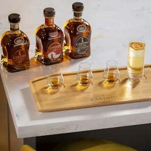 In einem abgedunkelten Lagerraum liegen viele Holzfässer auf Regalen übereinander.