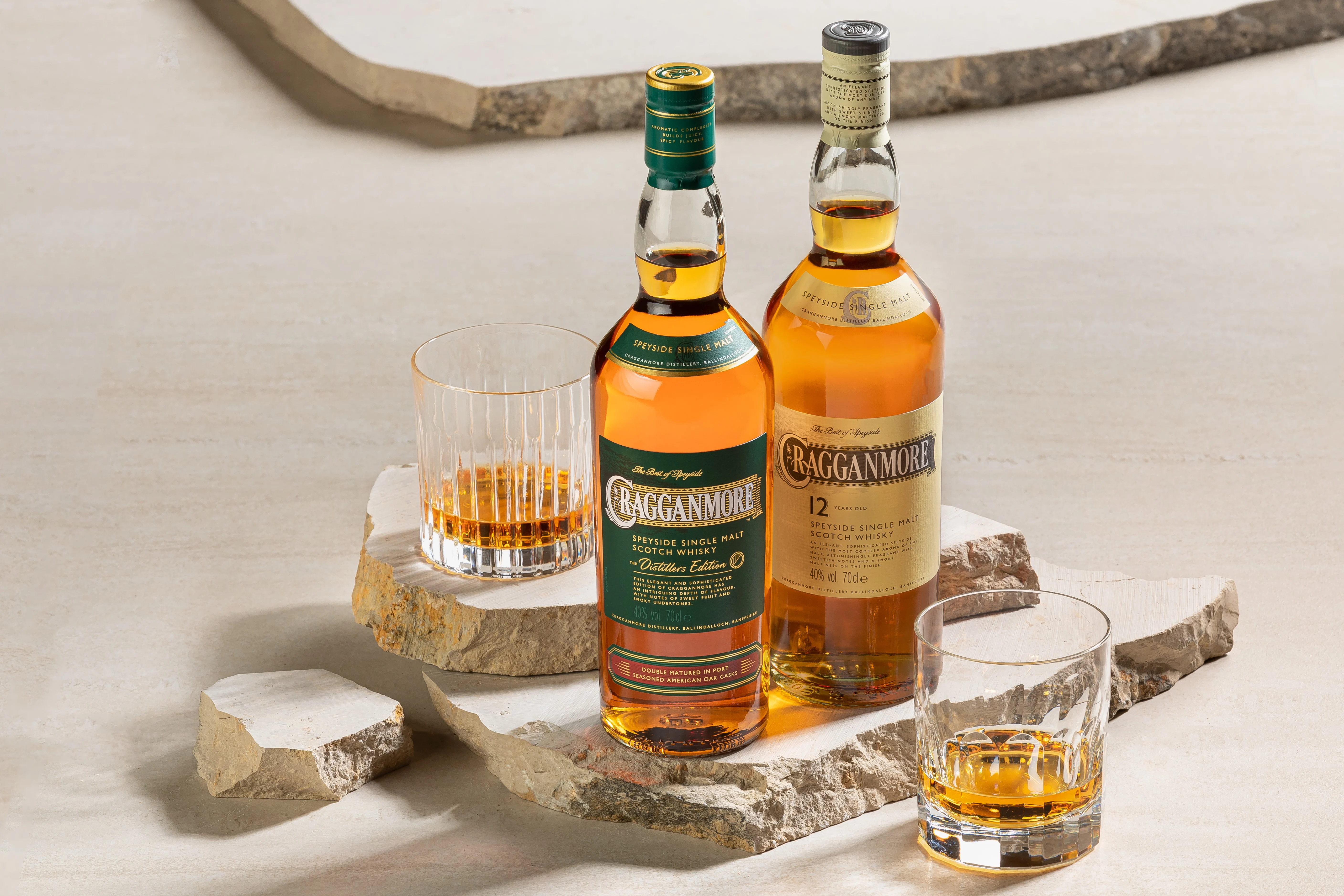 A man applies gold shimmer dust with a powder brush to a gold star printed on a wooden barrel. The barrel is branded in white lettering with ‘D & J McCallum Ltd, 1985 Cragganmore 1272’