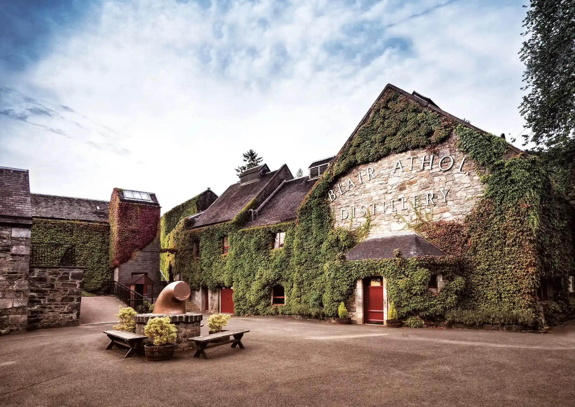 Blair Athol Distillery against blue skies