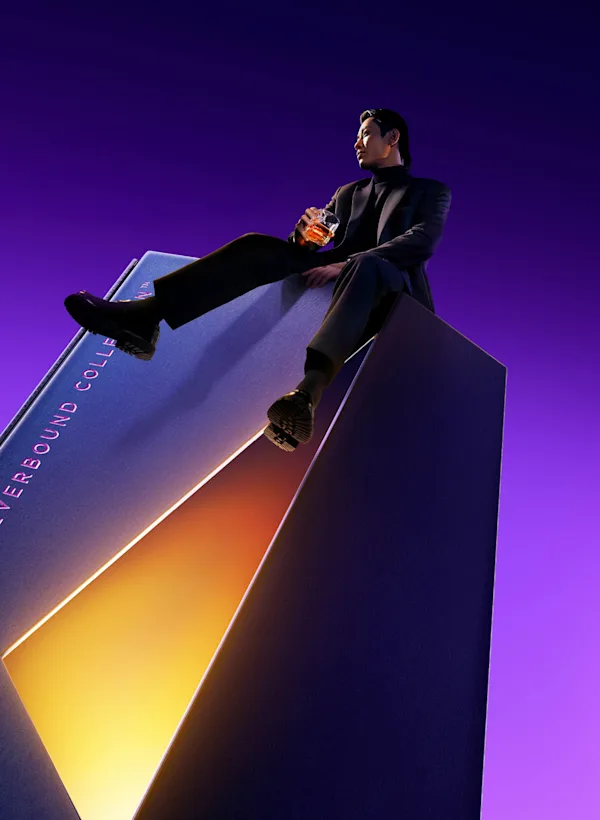Mortlach Neverbound Collection Release 01 key visual with bottle and male model sitting on packaging with purple background.