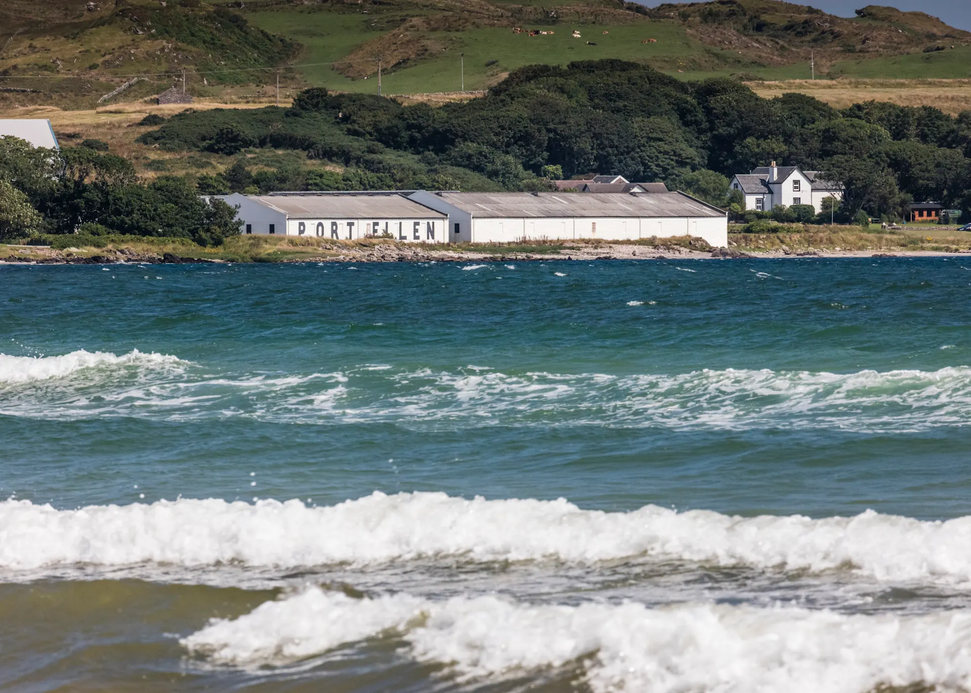 Port Ellen distillery is seen from across the sea