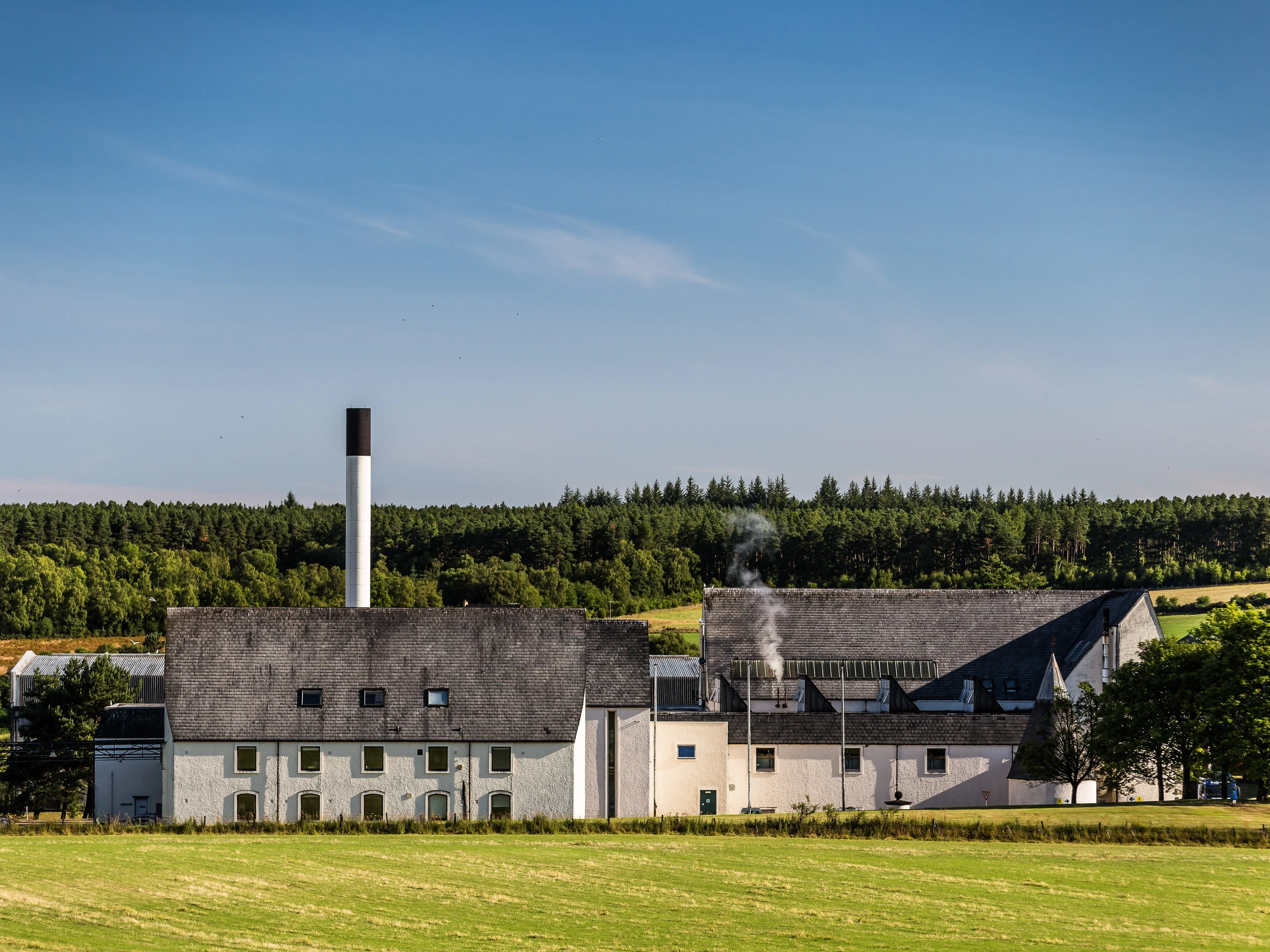 An external view of a distillery on a sunny day