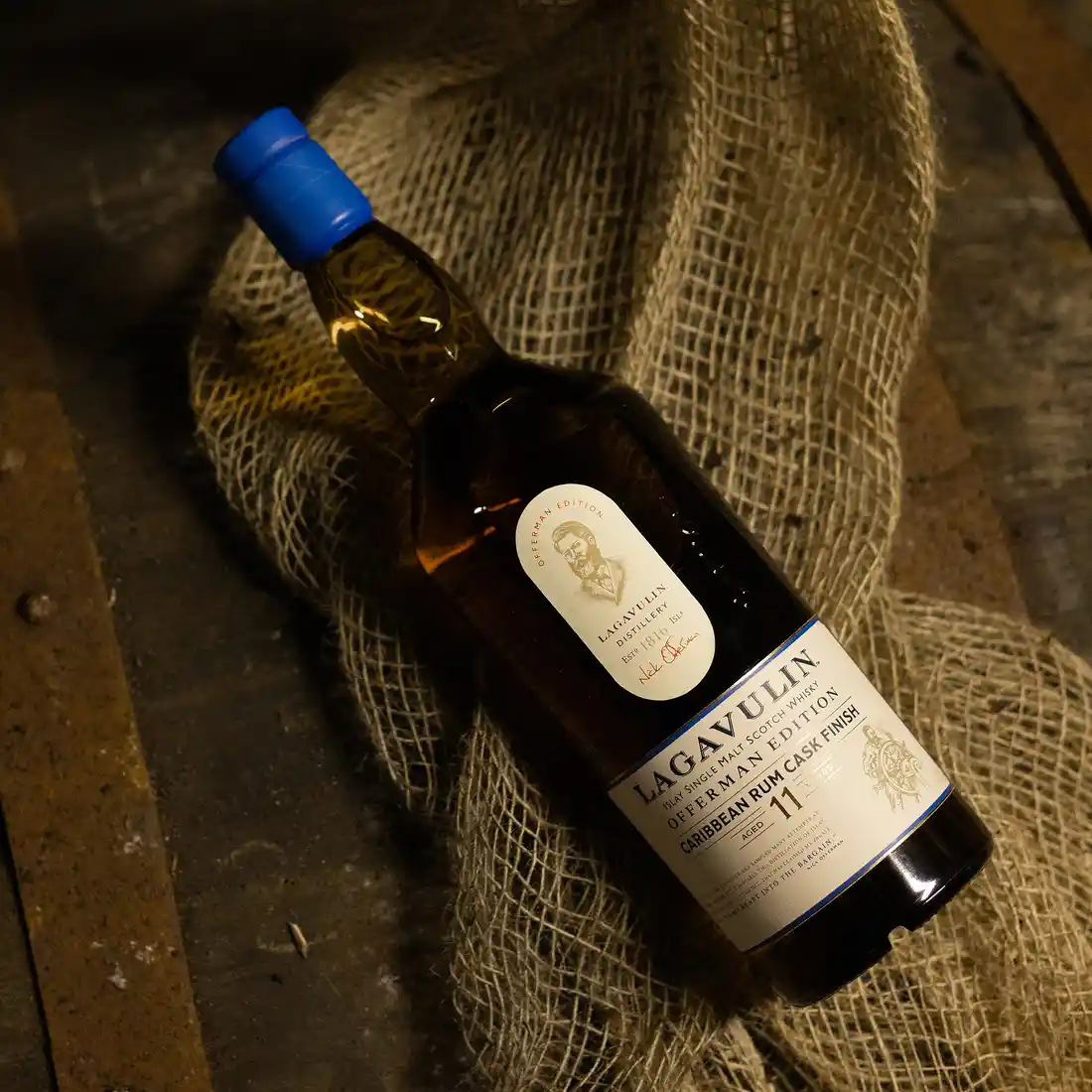 Lagavulin Offerman 2024 Caribbean Cask Finish Bottle placed above a sack