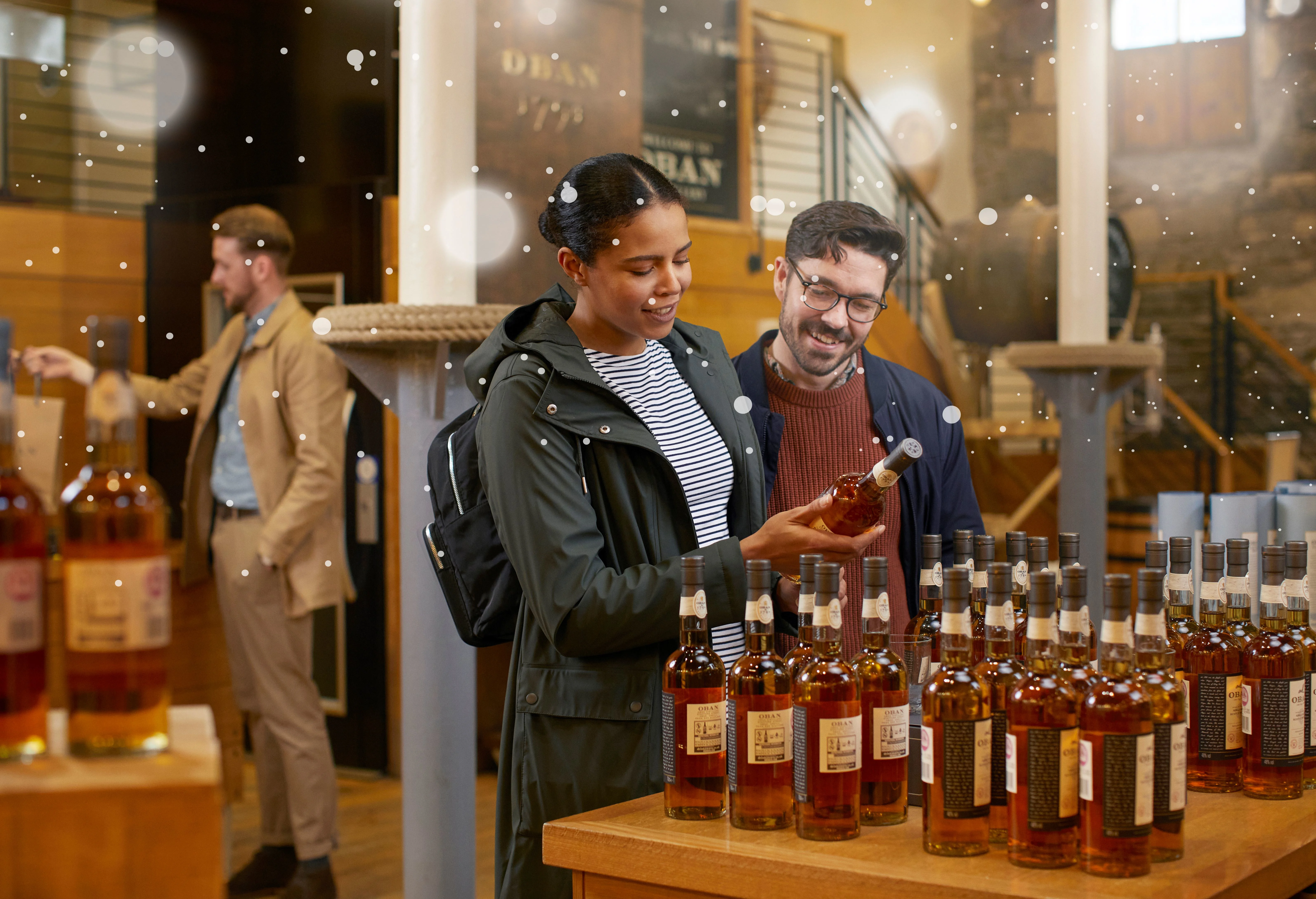 A couple visiting Oban retail shop and checking in one of the Oban special edition bottles 