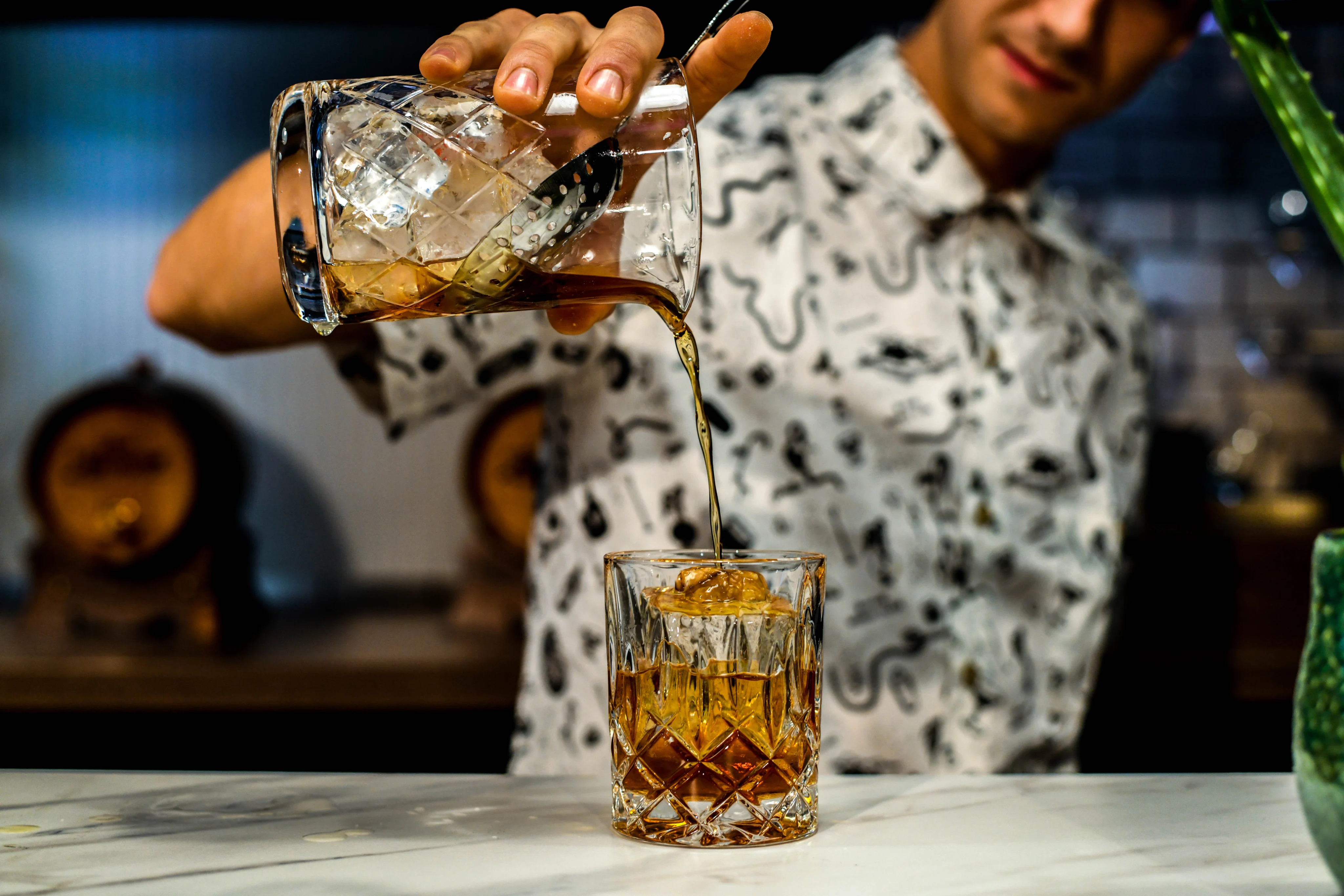 Rusty Nail Cocktail being poured into a glass
