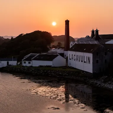 A shot of the Lagavulin distillery as the sun sets across the bay