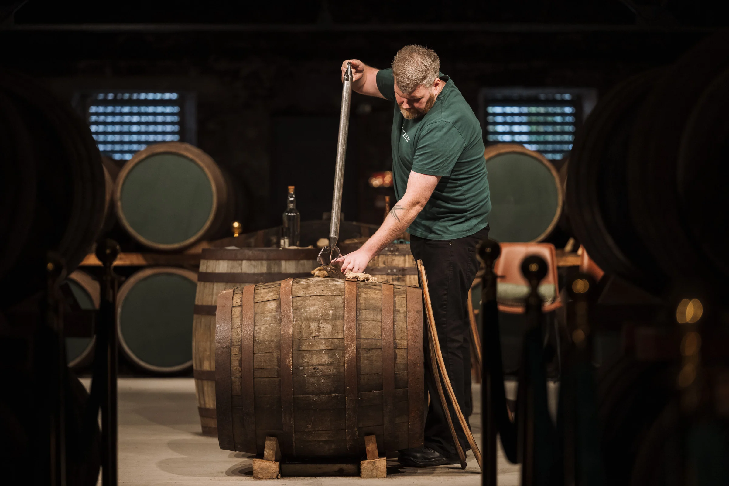 Image of distiller drawing spirit from cask
