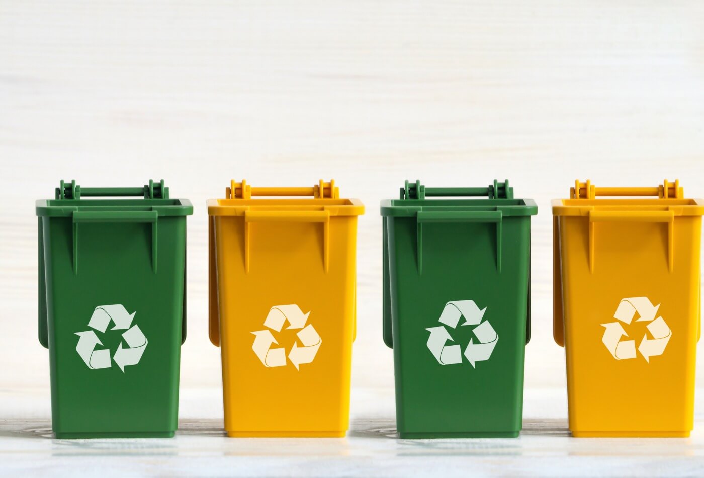 four-plastic-dumpsters-yellow-and-green-with-open-lids-the-ecology-picture-id1306315907 (1)