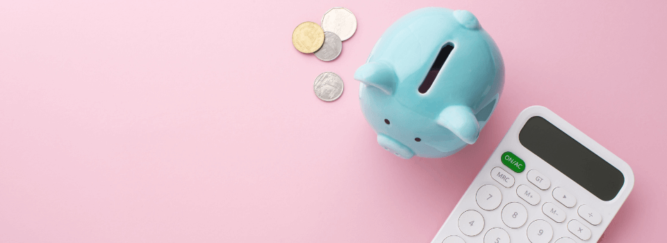 Piggy bank, calculator and coins on pink background