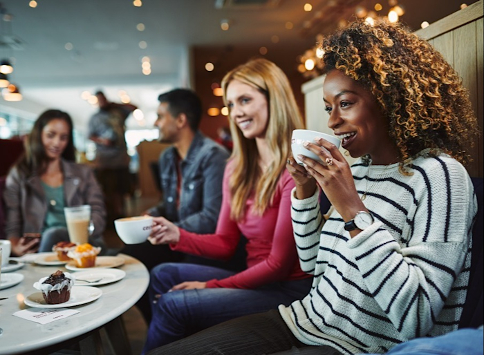 Zufriedene Gäste im Costa Kaffee genießen Kaffee