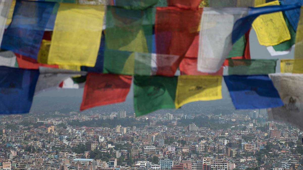 Flags fly over a Nepal devastated by earthquakes.