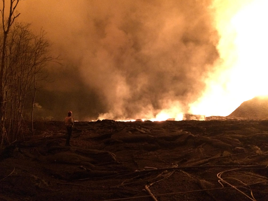 Geologist makes early morning observations of the lava fountain and channelized flow at fissure 8 in Leilani Estates.