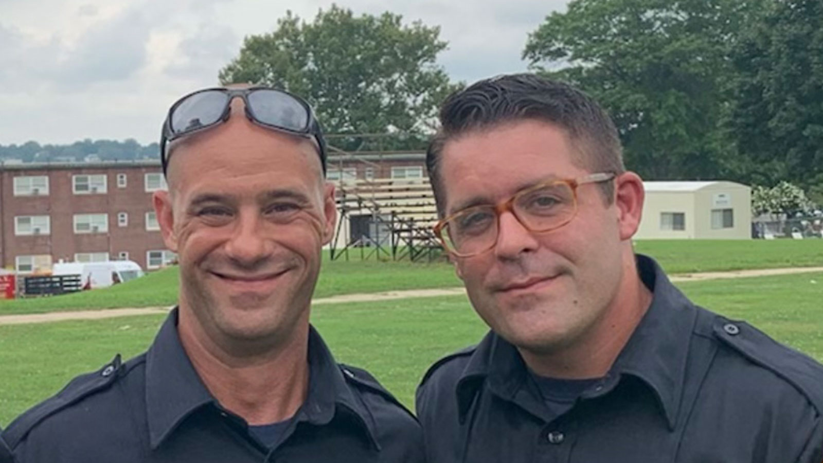 John Wakie stood in a portrait photo with a fellow firefighter