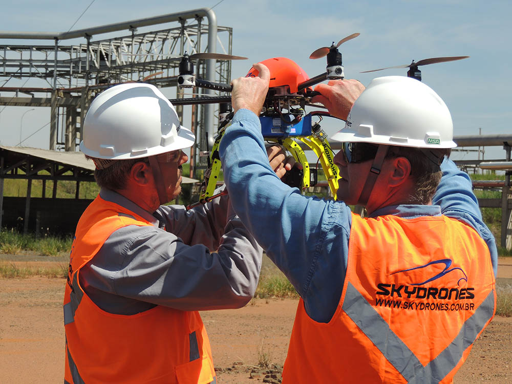 The SkyDrones team holding a drone ready for takeoff.