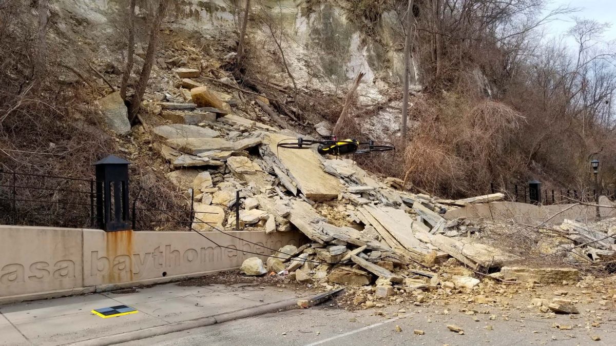 A drone hovering in front of the Wabasha Street rockslide.