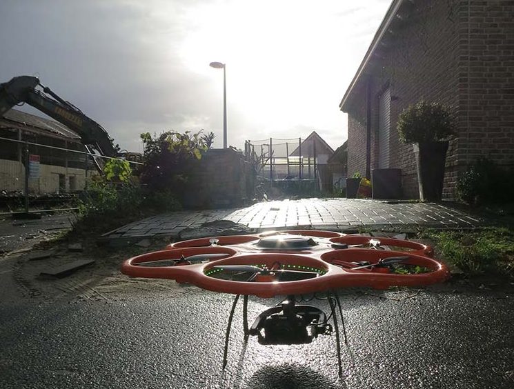 A rotary drone in front of earthquake-damaged buildings