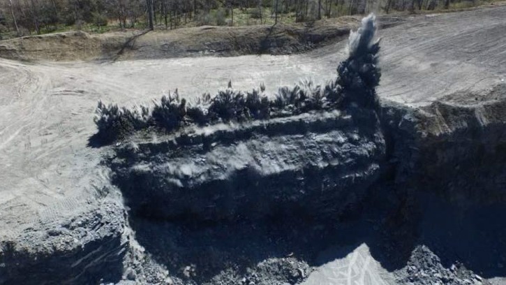 Aerial view of blasting a mining site/