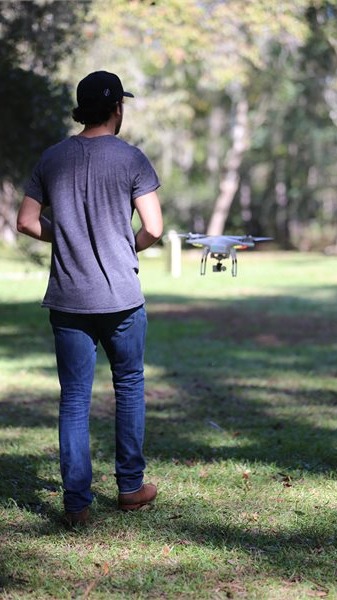 driver flying a DJI Phantom drone and capturing images