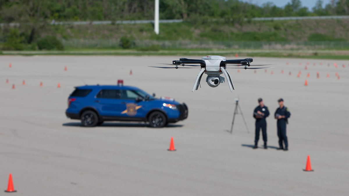 Two law enforcement officers demonstrate a drone flight