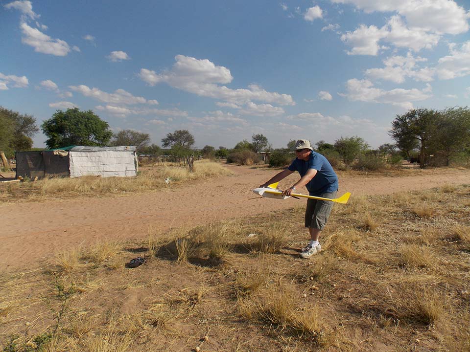 A man gets ready to launch a fixed wing drone.