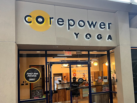 CorePower Yoga sign touted on a tan building with large glass windows