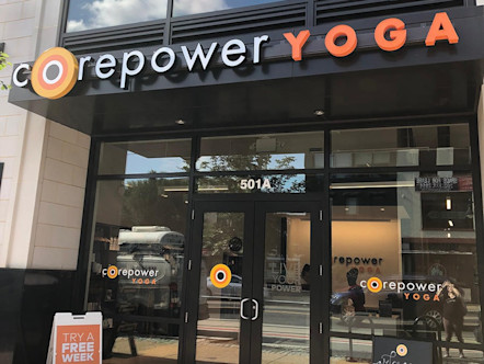 Glass streetfront entrance to Corepower Yoga H Street studio with Corepower banner