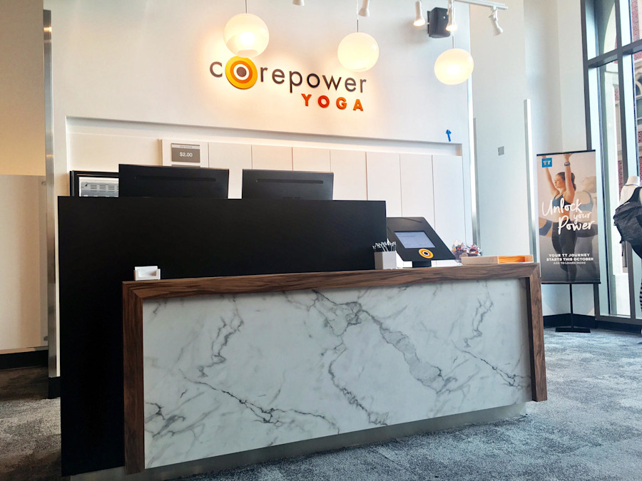 The front desk inside the USC Village studio, retail display and a drinks fridge alongside