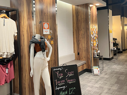 Wooden columns partitioning gray benches in a retail/lobby waiting and seating area