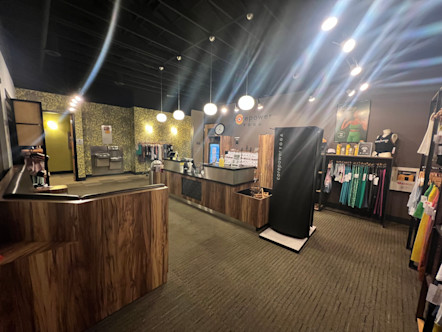 Wooden cabinets circling a retail center with bright merchandise and japandi style lighting overhead