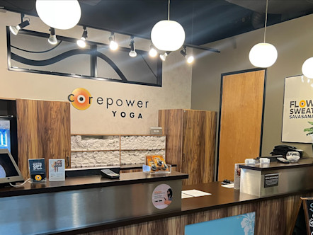 CorePower Yoga sign touted above freshly rolled towels behind a clean wooden front desk