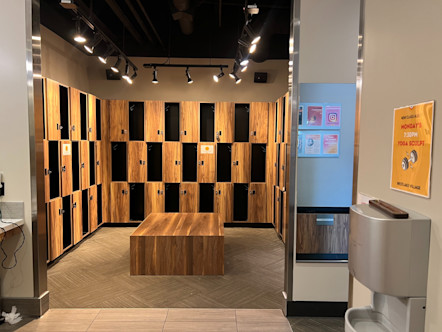 CPY Westlake Village locker room with alternating wooden lockers and cubby spaces surrounding a wooden center bench