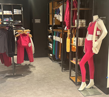 Hot pink yoga gear merchandised inside a studio