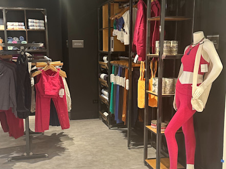 Hot pink yoga gear merchandised inside a studio