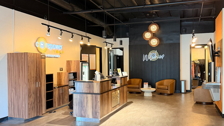 The front entrance and lobby, a tiered wooden desk beneath the CorePower Yoga lettering