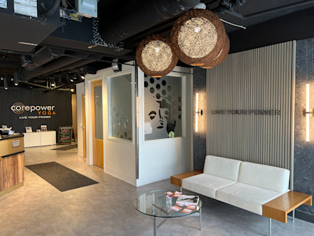 Hollywood CorePower Yoga studio entrance with a white suede couch and a glass coffee table 