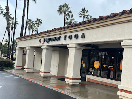 White Tuscan style building with large columns, red roofing and a CorePower Yoga sign