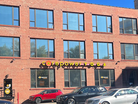 CorePower sign displayed on the red brick three-story building exterior of the Lakeview studio
