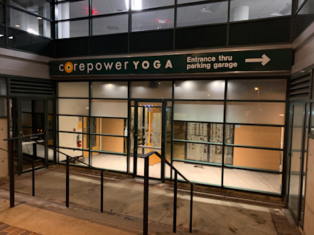 Floor to roof glass grid windows touting a CorePower Yoga sign 