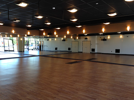 CorePower Yoga Winchester studio's naturally-lit studio space with wooden floors and mirrored walls