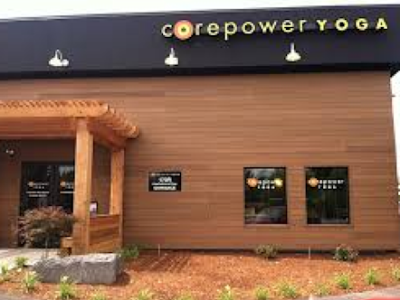 CorePower Yoga sign hung on the Cherry Hills studio's building wooden paneled exterior
