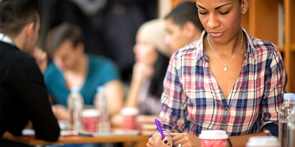 Woman sitting in a cafe studying