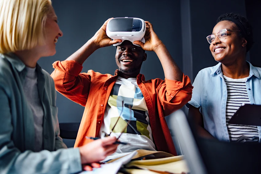 group of people laughing and playing virtual reality