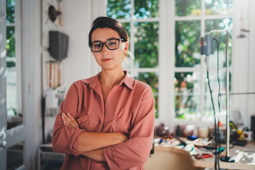 Female student standing in work environment
