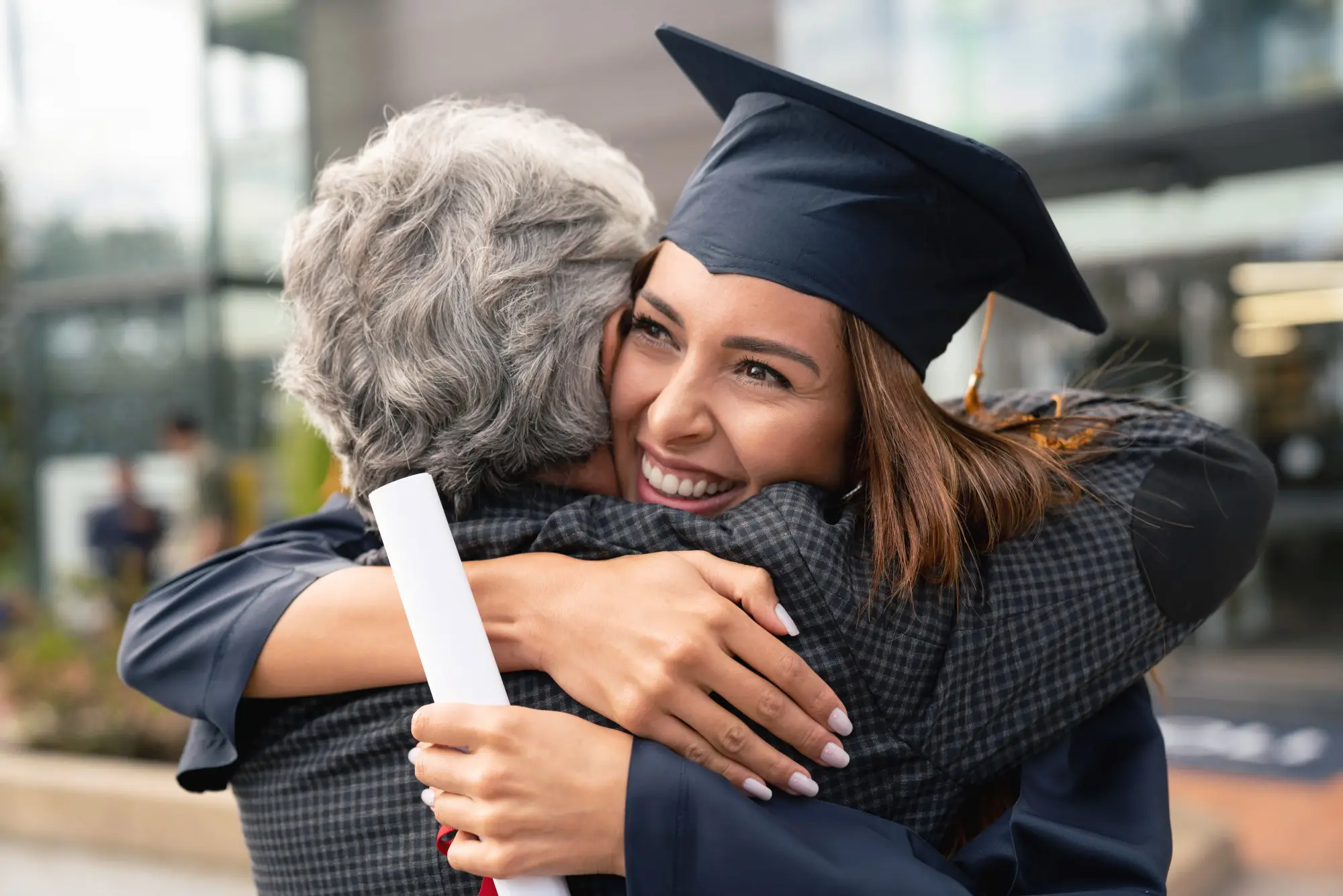 College graduate hugging a family member