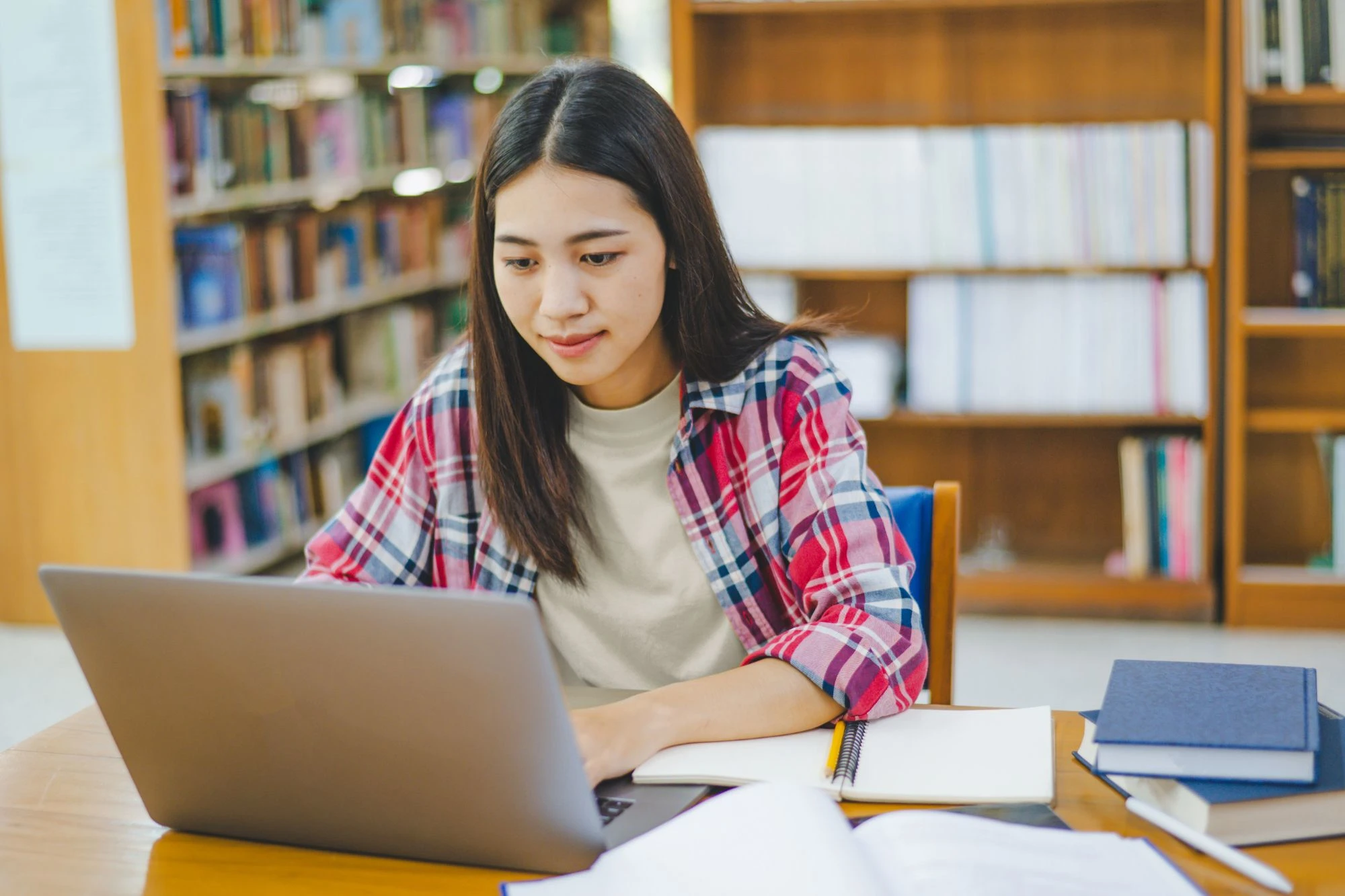 Student at library working on laptop