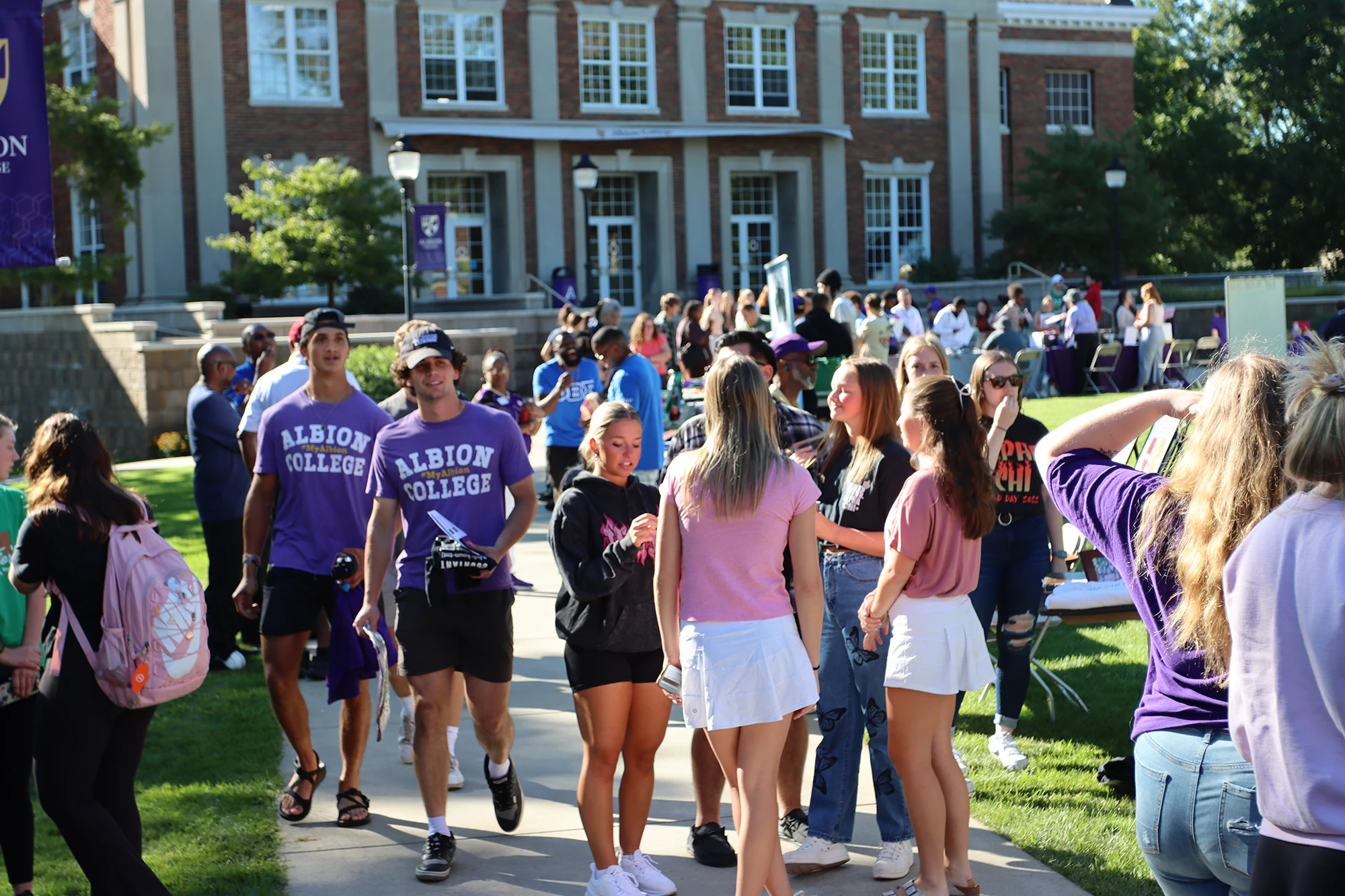 Albion College students socializing outdoors on campus for an event.