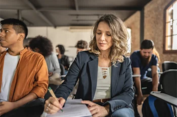 dearborn - man and woman in classroom taking notes