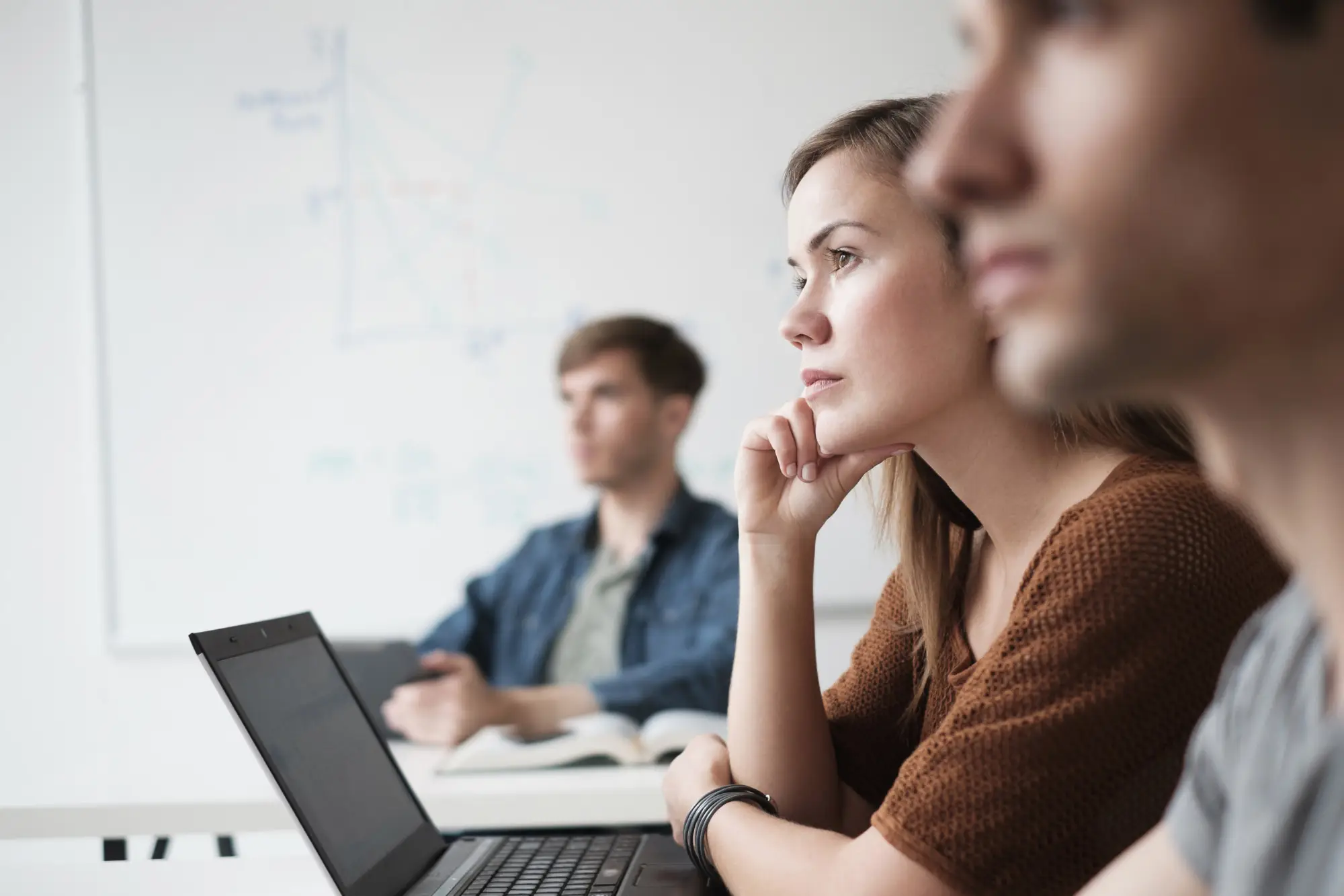 Students in class with open laptops.