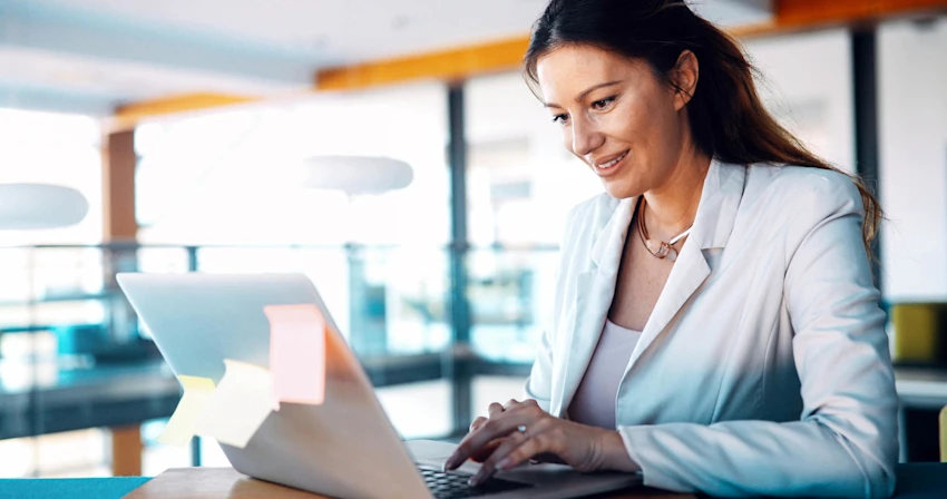 Business Woman In White Blazer Working On Laptop